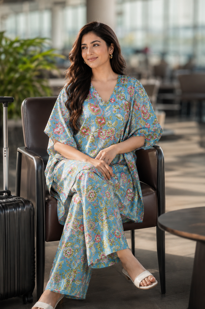 Woman wearing floral kaftan wide leg pants co-ord set at airport - front view