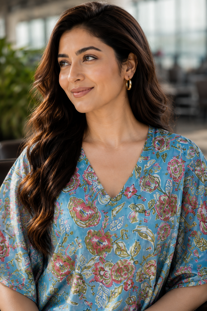 Woman wearing floral kaftan co-ord set at airport - back view