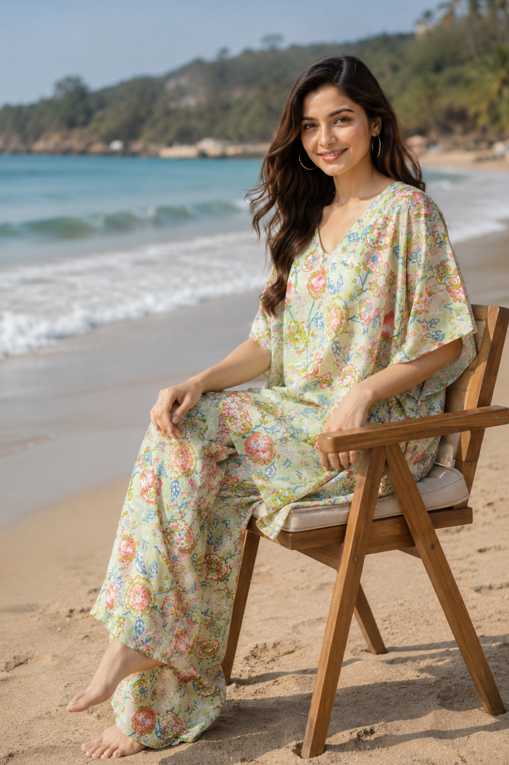 Woman sitting on beach chair wearing sage green floral kaftan wide leg pants co-ord set