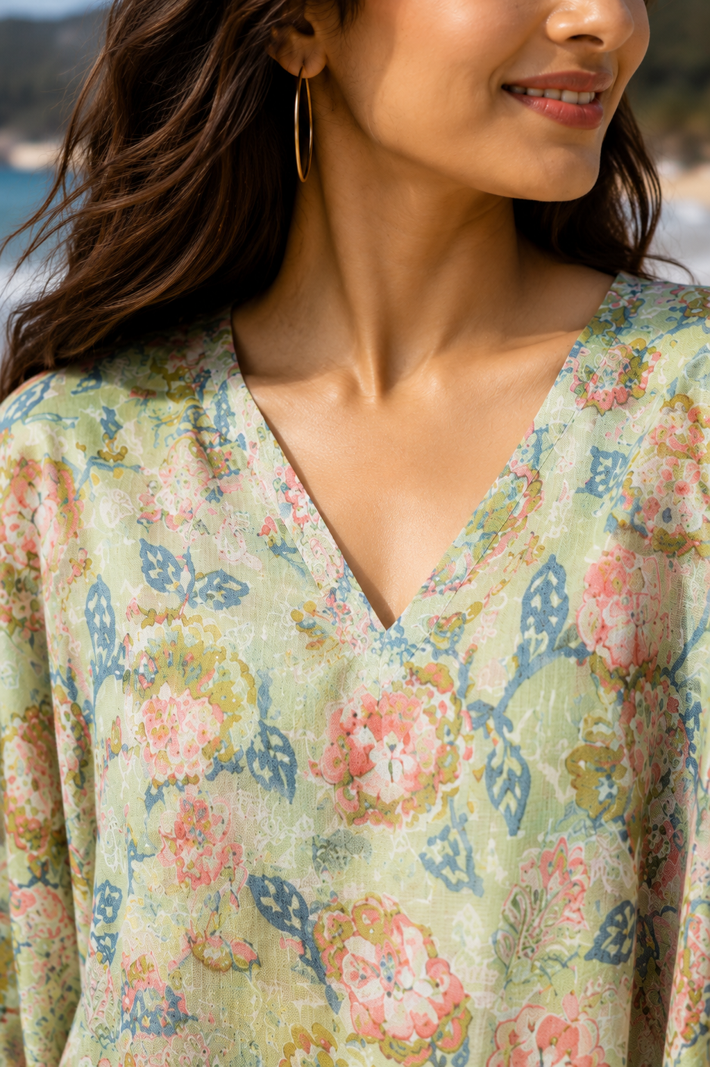 Close up of sage green floral kaftan V-neckline and fabric print detail