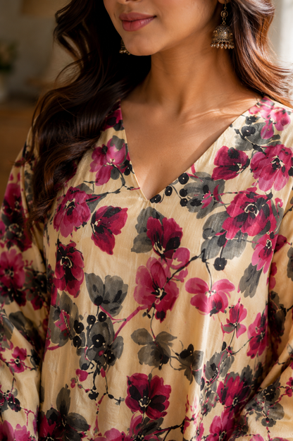 Woman wearing cream magenta floral kaftan co-ord set seated on chair - lifestyle shot
